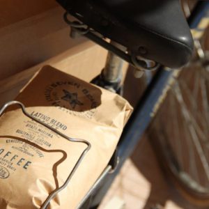 Coffee Circus Latino Blend coffee bag placed on a bicycle rack